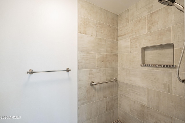 bathroom with a tile shower