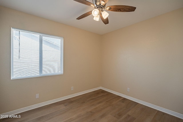 empty room featuring baseboards, wood finished floors, and a healthy amount of sunlight