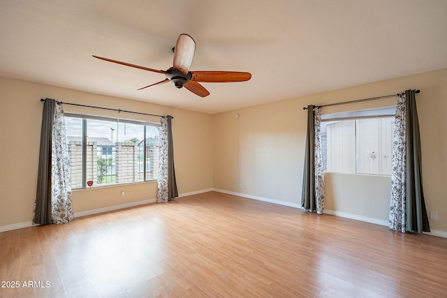 unfurnished room with light wood-type flooring, ceiling fan, and baseboards