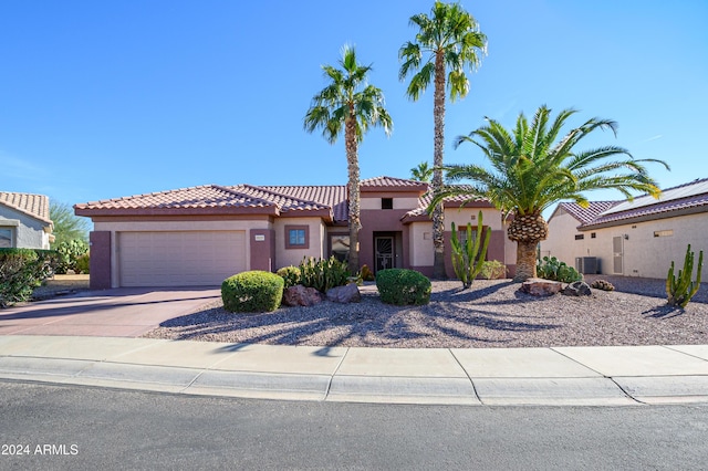 mediterranean / spanish home with central AC and a garage