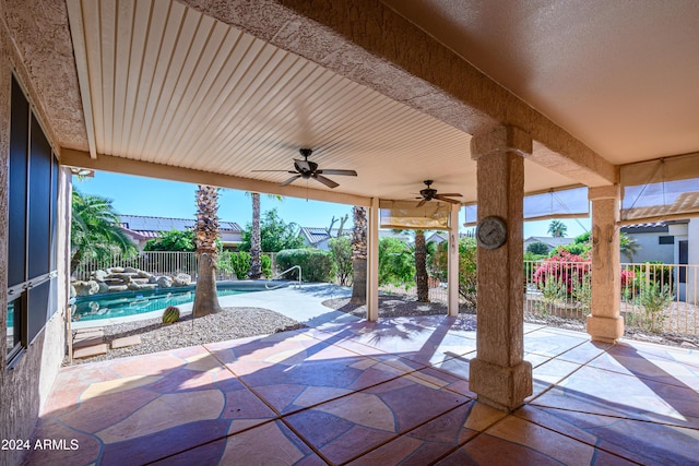 view of patio / terrace with ceiling fan and a fenced in pool