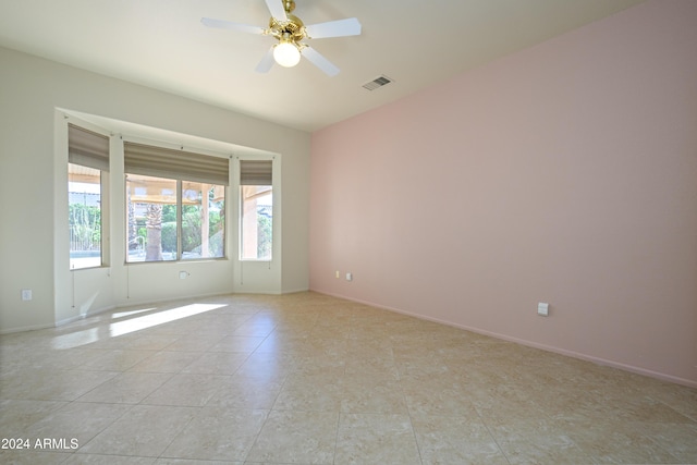 empty room featuring ceiling fan and light tile patterned flooring