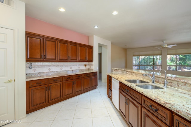 kitchen with backsplash, light stone countertops, sink, and light tile patterned flooring