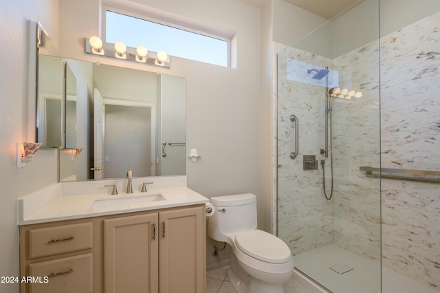 bathroom featuring tiled shower, vanity, toilet, and tile patterned flooring