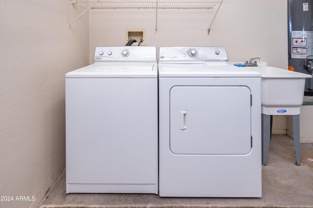 washroom with washer and dryer and gas water heater