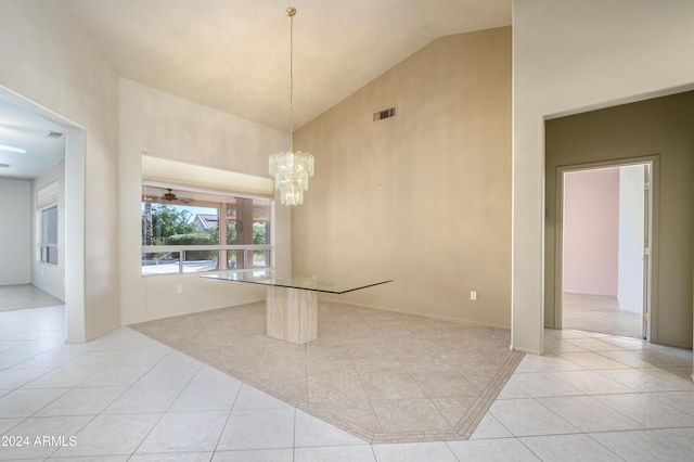 unfurnished room with light tile patterned flooring, a chandelier, and high vaulted ceiling