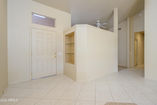 tiled foyer featuring ceiling fan