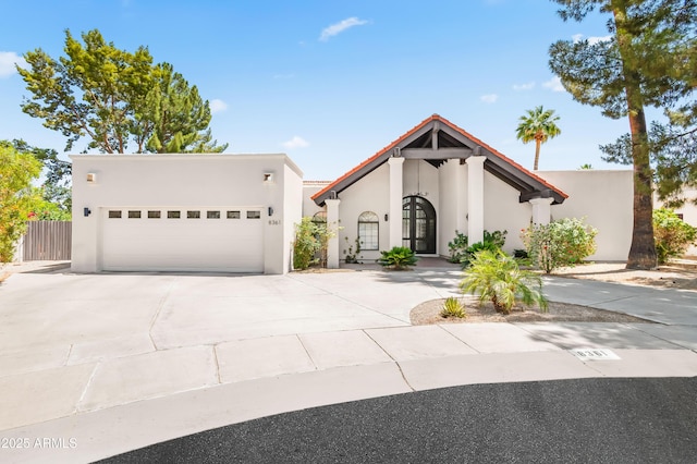 8361 E San Rafael Dr, Scottsdale, AZ 85258 - view of front of property with stucco siding, concrete driveway, and an attached garage