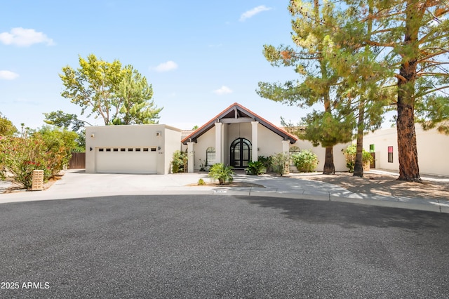8361 E San Rafael Dr, Scottsdale, AZ 85258 - view of front facade featuring stucco siding, a garage, and concrete driveway