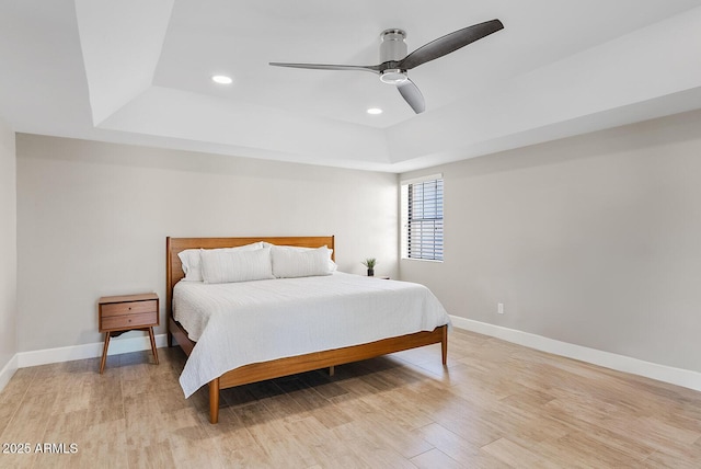 8361 E San Rafael Dr, Scottsdale, AZ 85258 - bedroom with a tray ceiling, recessed lighting, light wood-style flooring, and a ceiling fan