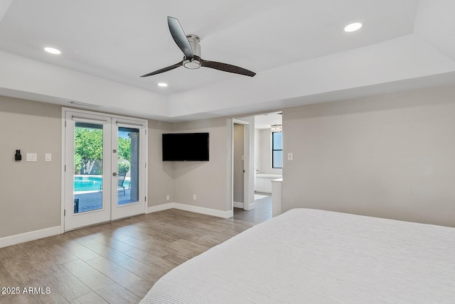 8361 E San Rafael Dr, Scottsdale, AZ 85258 - bedroom with access to outside, wood finished floors, a raised ceiling, recessed lighting, and connected bathroom
