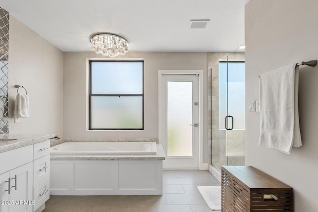 8361 E San Rafael Dr, Scottsdale, AZ 85258 - full bathroom featuring a garden tub, a stall shower, plenty of natural light, and tile patterned floors