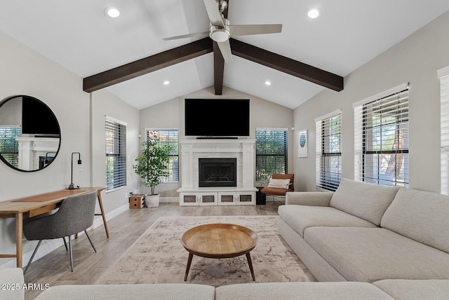 8361 E San Rafael Dr, Scottsdale, AZ 85258 - living area with light wood-style floors, recessed lighting, a fireplace with raised hearth, and ceiling fan