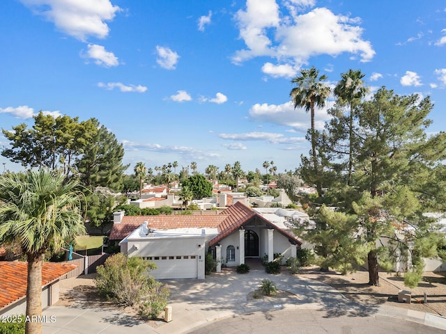 8361 E San Rafael Dr, Scottsdale, AZ 85258 - mediterranean / spanish home with an attached garage, driveway, a tile roof, and stucco siding