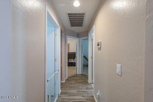 corridor with wood-type flooring