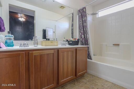 bathroom with tile patterned flooring, shower / tub combo, and vanity