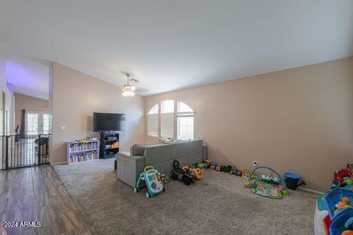 recreation room with hardwood / wood-style flooring, plenty of natural light, ceiling fan, and lofted ceiling