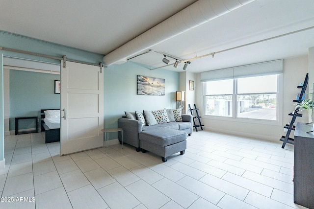 tiled living room featuring rail lighting and a barn door