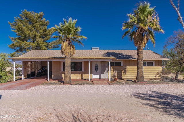 ranch-style home featuring a carport