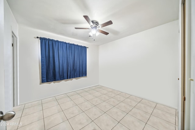 tiled empty room with ceiling fan