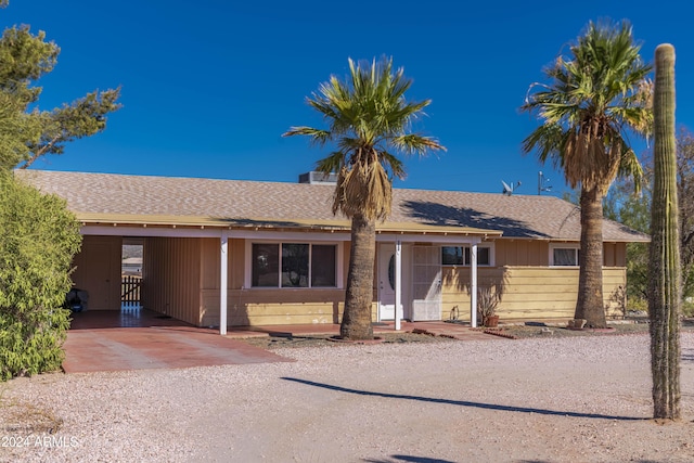 ranch-style home featuring a carport