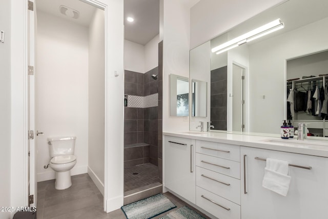 540 W Mariposa St Unit 9, Phoenix, AZ 85013 - bathroom featuring double vanity, toilet, tiled shower, baseboards, and tile patterned flooring