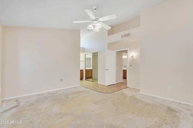 unfurnished room with baseboards, visible vents, unfinished concrete flooring, ceiling fan, and high vaulted ceiling