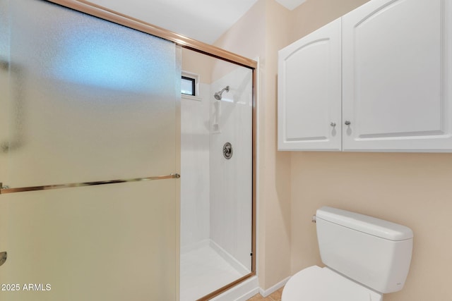 bathroom featuring toilet and a stall shower