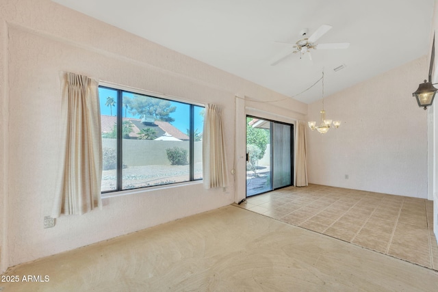 tiled spare room with vaulted ceiling, plenty of natural light, and ceiling fan with notable chandelier