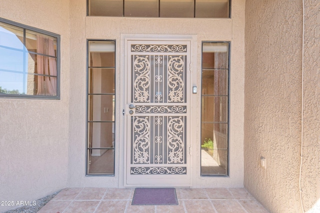 view of exterior entry with stucco siding