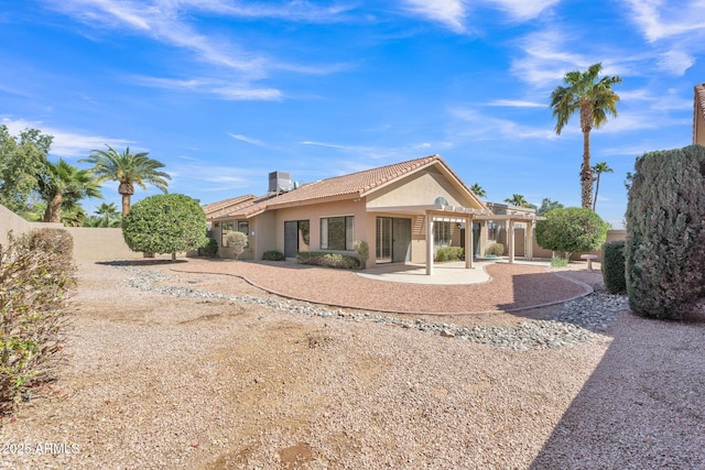 back of house with a patio area, fence, a tiled roof, and stucco siding