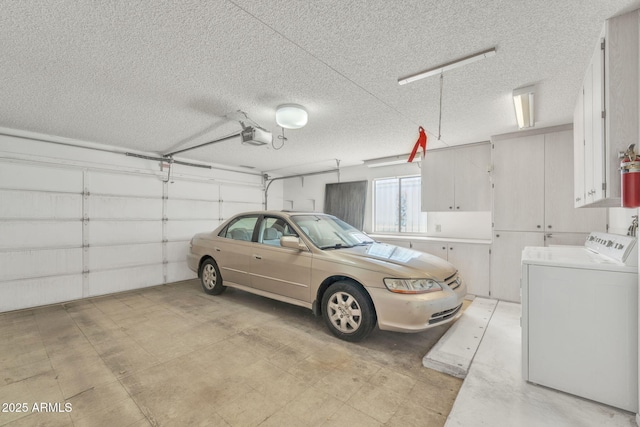 garage featuring washing machine and dryer and a garage door opener