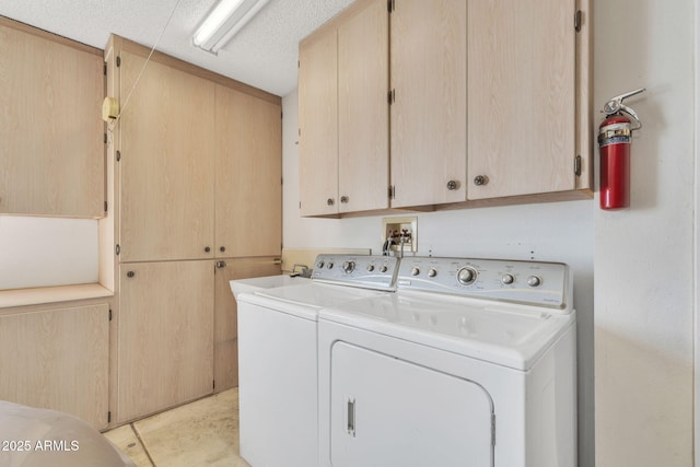 washroom with washing machine and clothes dryer and cabinet space