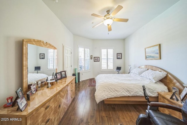 bedroom featuring dark wood-type flooring, baseboards, and ceiling fan