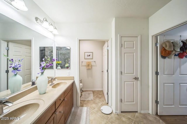 full bathroom with a sink, tile patterned flooring, toilet, and double vanity