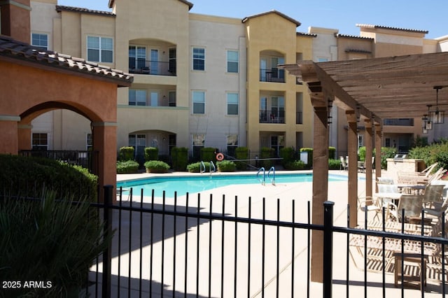 pool featuring fence and a patio