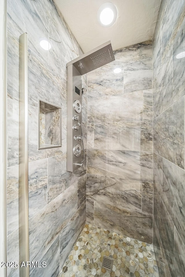 bathroom with tiled shower