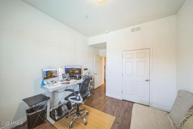 office featuring baseboards, dark wood-style flooring, and visible vents