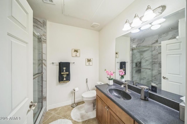 full bathroom featuring a stall shower, vanity, baseboards, tile patterned floors, and toilet