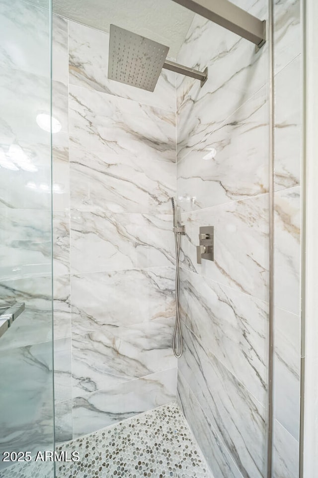 bathroom with a marble finish shower
