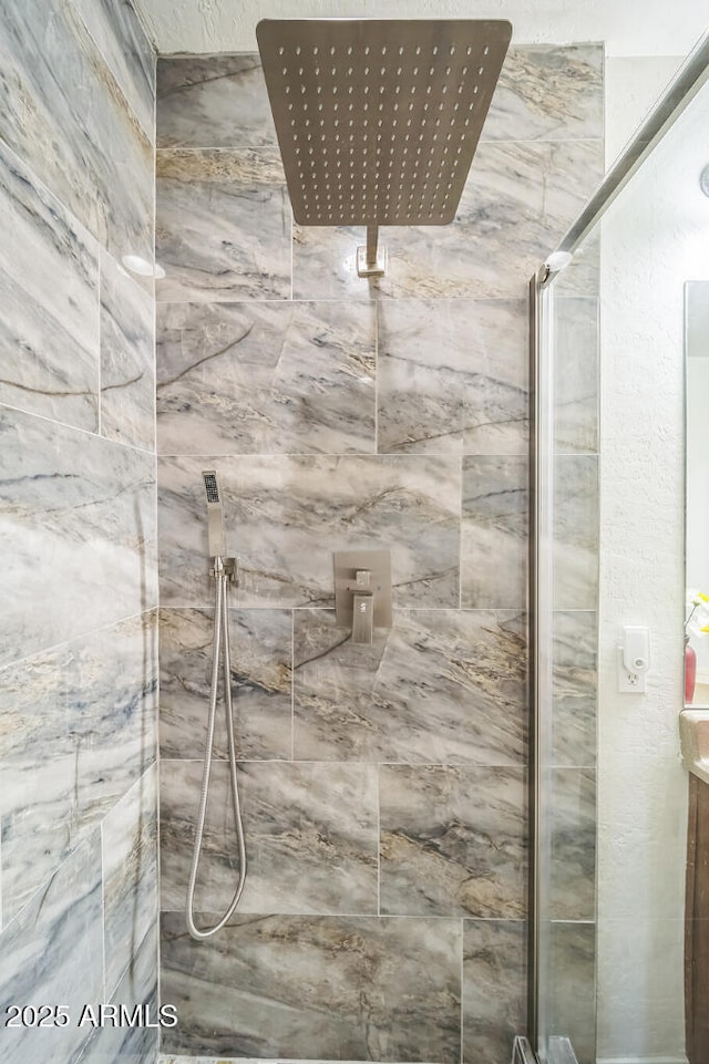 full bathroom featuring a marble finish shower