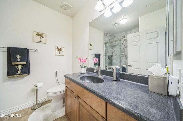 full bathroom featuring vanity, visible vents, toilet, baseboards, and a shower stall