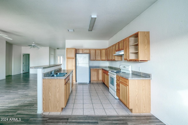 kitchen with ceiling fan, sink, white appliances, light brown cabinetry, and light wood-type flooring