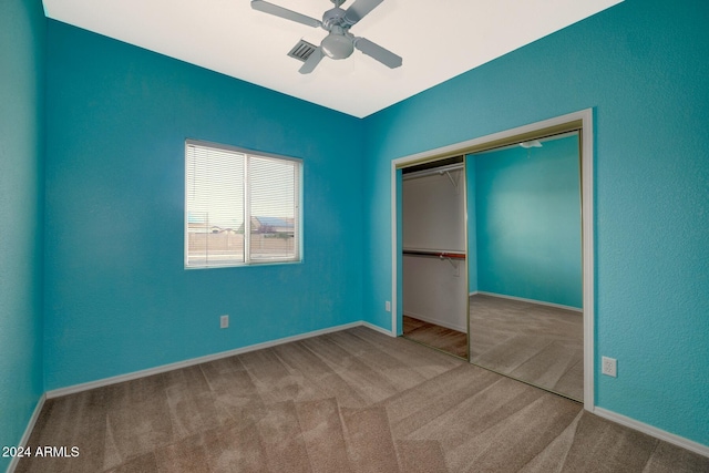 unfurnished bedroom with ceiling fan, a closet, and carpet