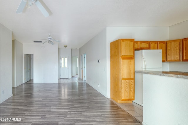 kitchen with ceiling fan, white refrigerator, and light wood-type flooring