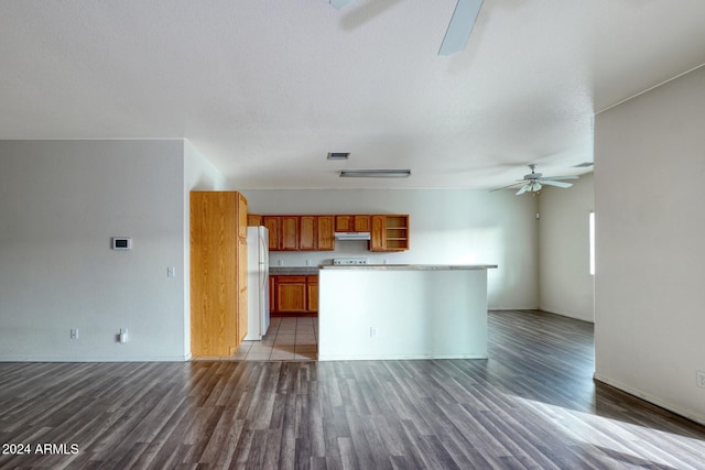 unfurnished living room featuring ceiling fan, dark hardwood / wood-style flooring, and a textured ceiling