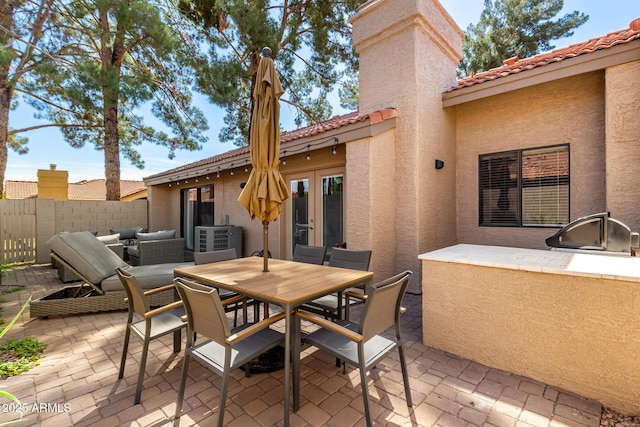 view of patio / terrace with french doors, outdoor dining area, area for grilling, and fence