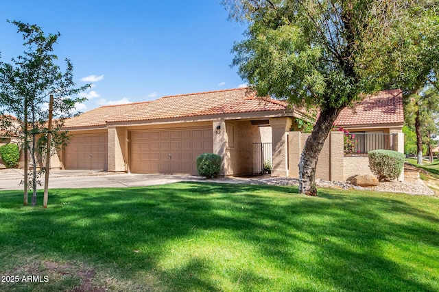 ranch-style house with a tile roof, driveway, a front lawn, and a garage