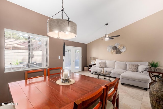 dining room with light tile patterned flooring, a ceiling fan, high vaulted ceiling, and french doors