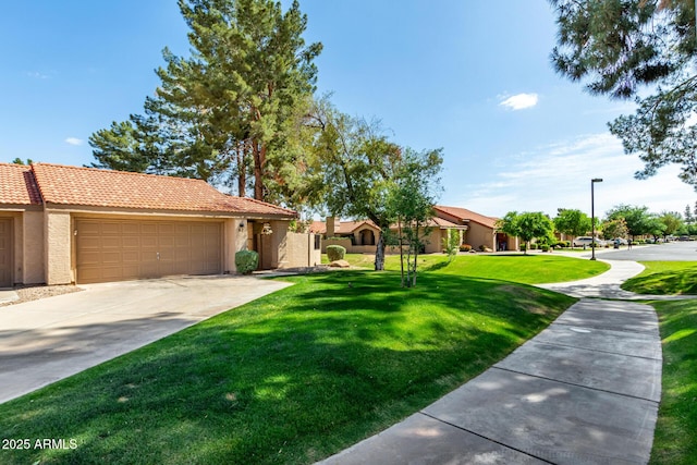 single story home featuring a tiled roof, concrete driveway, an attached garage, stucco siding, and a front yard
